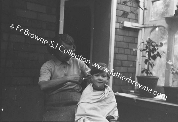 MRS R J MARTIN (ETTE) AND GRANDSON (JOHNNY)  CUTTING HIS HAIR  AT LOWOOD